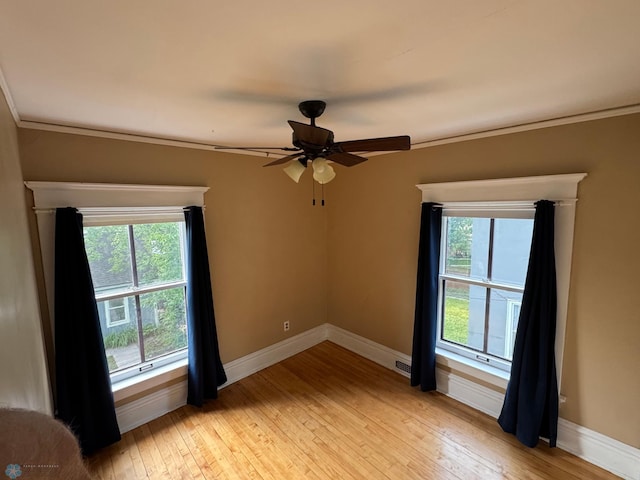 619 University Dr S, Fargo, ND 58103 - spare room featuring crown molding, light wood-style floors, healthy amount of natural light, and a ceiling fan