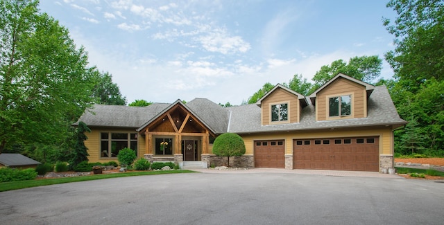 8271 Barton Ave NW, Buffalo, MN 55313 - view of front of house with stone siding, asphalt driveway, and a shingled roof