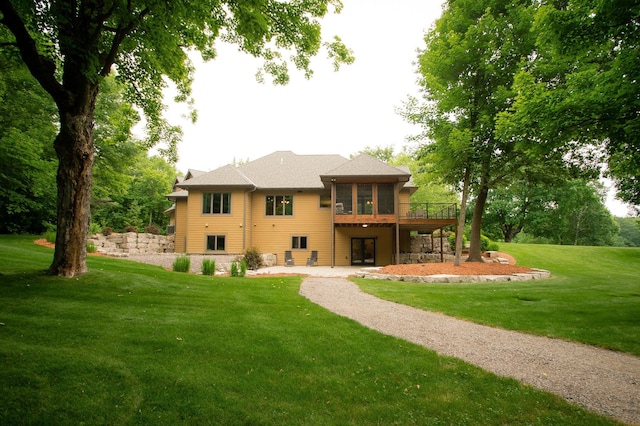 8271 Barton Ave NW, Buffalo, MN 55313 - rear view of house featuring french doors, a sunroom, a patio, a lawn, and a wooden deck