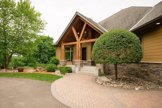 8271 Barton Ave NW, Buffalo, MN 55313 - doorway to property with stone siding and roof with shingles