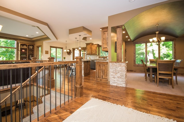 8271 Barton Ave NW, Buffalo, MN 55313 - kitchen with brown cabinets, a chandelier, hardwood / wood-style floors, dishwasher, and recessed lighting