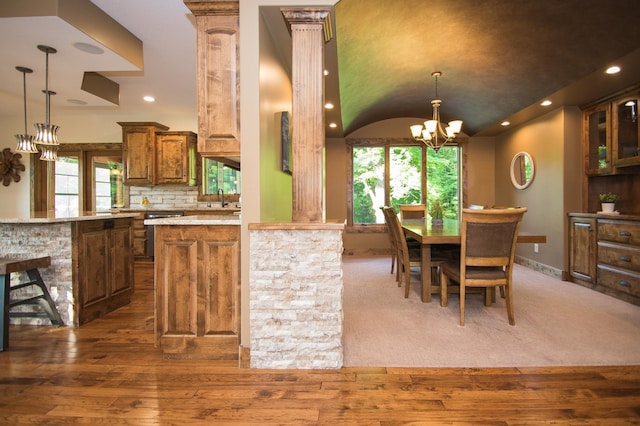 8271 Barton Ave NW, Buffalo, MN 55313 - kitchen featuring a chandelier, brown cabinets, dark wood-type flooring, recessed lighting, and lofted ceiling