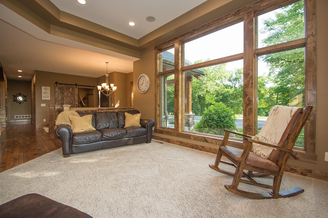 8271 Barton Ave NW, Buffalo, MN 55313 - living area with a barn door, recessed lighting, wood finished floors, and a chandelier