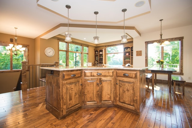 8271 Barton Ave NW, Buffalo, MN 55313 - kitchen with a tray ceiling, a chandelier, brown cabinets, and dark wood finished floors