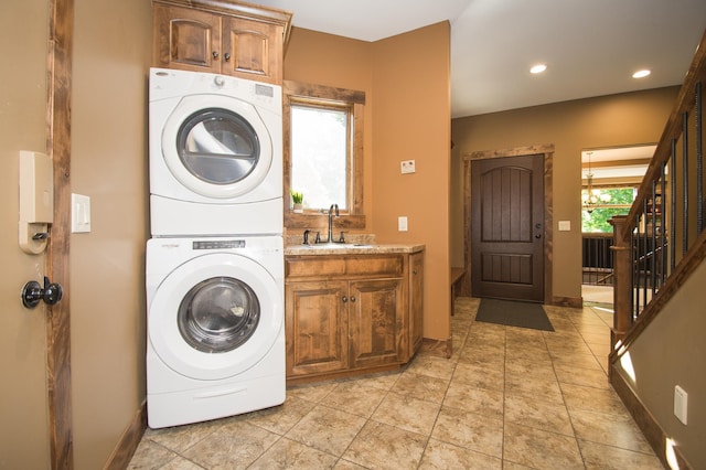 8271 Barton Ave NW, Buffalo, MN 55313 - laundry room featuring stacked washer / dryer, cabinet space, and recessed lighting
