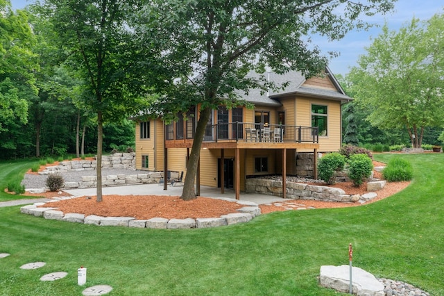 8271 Barton Ave NW, Buffalo, MN 55313 - back of house featuring a patio area, a yard, a wooden deck, and a sunroom