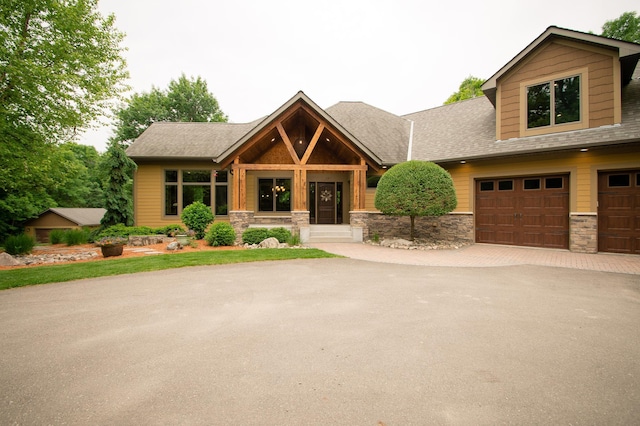 8271 Barton Ave NW, Buffalo, MN 55313 - view of front of house with stone siding, driveway, and a shingled roof