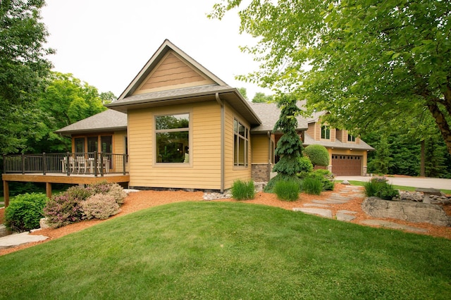 8271 Barton Ave NW, Buffalo, MN 55313 - rear view of property featuring an attached garage, a yard, a wooden deck, a shingled roof, and concrete driveway