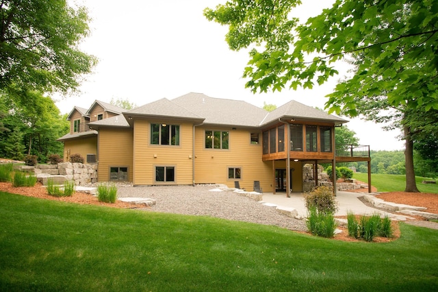 8271 Barton Ave NW, Buffalo, MN 55313 - back of property featuring a sunroom, a patio, and a yard