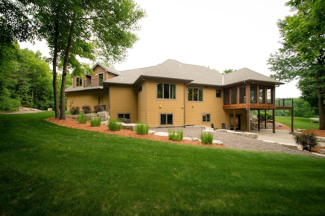 8271 Barton Ave NW, Buffalo, MN 55313 - rear view of property with a sunroom, a yard, and a patio area