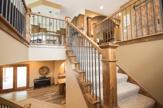 8271 Barton Ave NW, Buffalo, MN 55313 - stairs with a high ceiling, wood finished floors, recessed lighting, and arched walkways