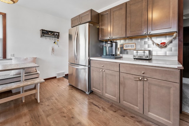 632 Quince St, Duluth, MN 55811 - kitchen with freestanding refrigerator, light wood-style floors, and light countertops