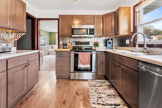 632 Quince St, Duluth, MN 55811 - kitchen with appliances with stainless steel finishes, light wood-type flooring, plenty of natural light, light countertops, and recessed lighting