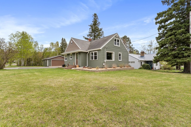 632 Quince St, Duluth, MN 55811 - view of front of property with a front yard, a detached garage, an outbuilding, and a chimney