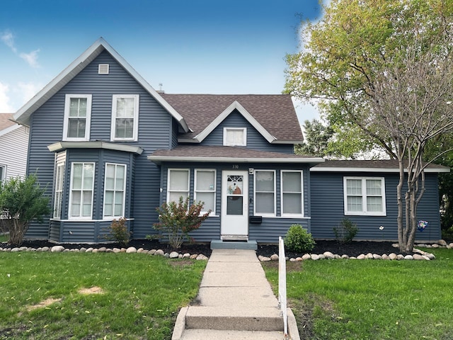 330 10th Ave, Granite Falls, MN 56241 - view of front of house with roof with shingles and a front lawn