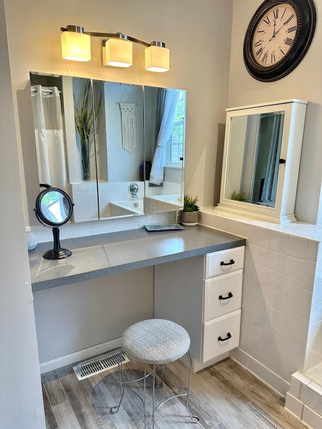 7495 Hillsdale Loop NW, Walker, MN 56484 - bathroom featuring wood finished floors, vanity, and tile walls