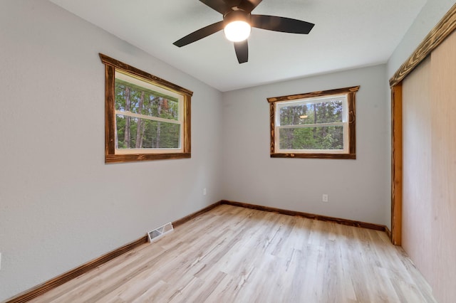 185 Olson Rd, Thomson Twp, MN 55733 - unfurnished bedroom with multiple windows, light wood-style flooring, ceiling fan, and a closet