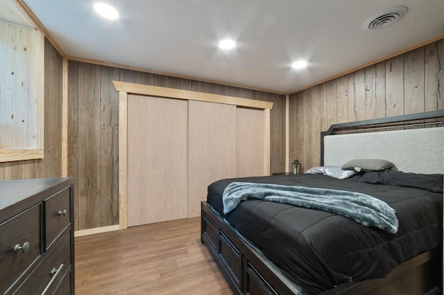 185 Olson Rd, Thomson Twp, MN 55733 - bedroom with wood walls, light wood finished floors, and a closet