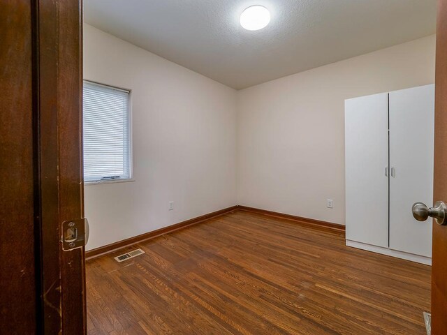 4021 Colfax Ave N, Minneapolis, MN 55412 - spare room with wood finished floors and baseboards