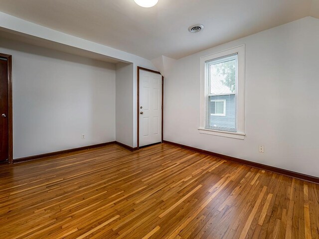 4021 Colfax Ave N, Minneapolis, MN 55412 - spare room with wood-type flooring and vaulted ceiling
