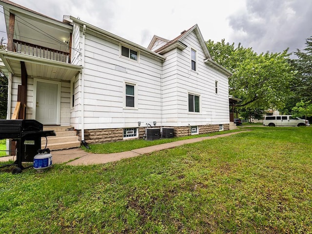 4021 Colfax Ave N, Minneapolis, MN 55412 - view of property exterior with a yard, entry steps, and a balcony