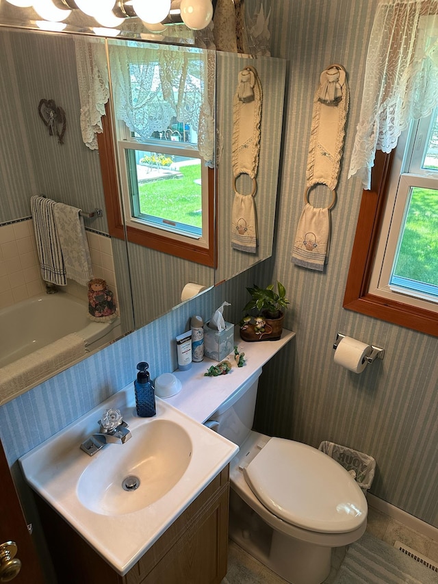 925 Willow St W, Detroit Lakes, MN 56501 - full bath with wallpapered walls, vanity, and a tub