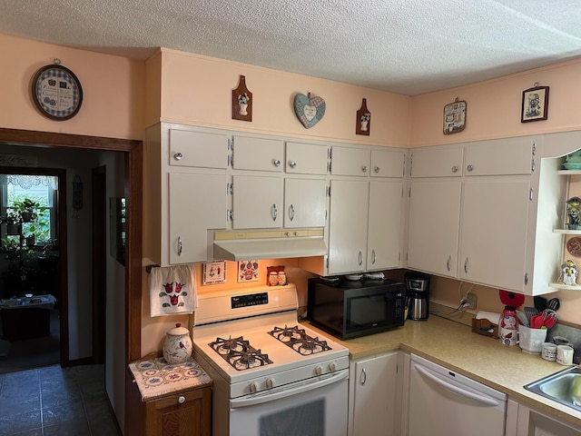 925 Willow St W, Detroit Lakes, MN 56501 - kitchen featuring white appliances, under cabinet range hood, light countertops, white cabinets, and a textured ceiling