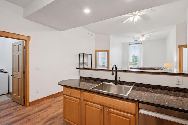 30 Main St S Unit 5E, Pine City, MN 55063 - kitchen with stainless steel dishwasher, light wood-type flooring, a ceiling fan, dark stone countertops, and open floor plan