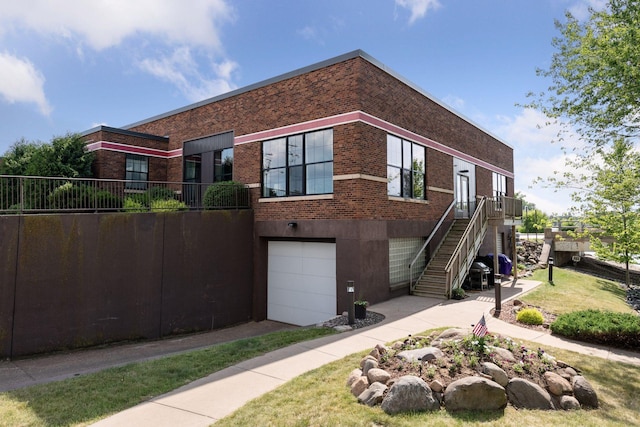 30 Main St S Unit 5E, Pine City, MN 55063 - view of front of home with brick siding, a garage, and stairway