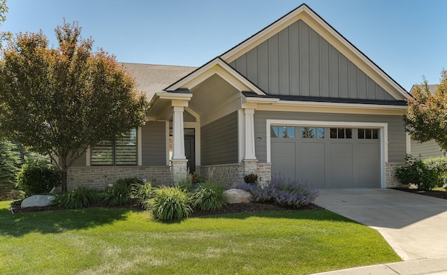1062 Fox Hill Ln SW, Rochester, MN 55902 - craftsman house with board and batten siding, stone siding, a front lawn, and a garage