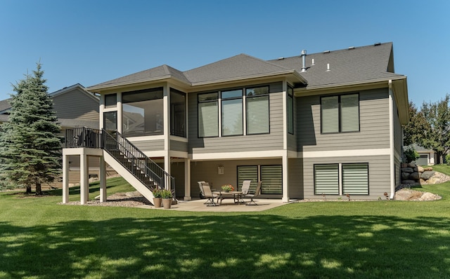 1062 Fox Hill Ln SW, Rochester, MN 55902 - rear view of property with a sunroom, a patio area, stairway, and a yard