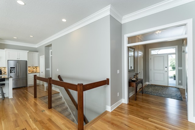 1062 Fox Hill Ln SW, Rochester, MN 55902 - foyer entrance featuring light wood finished floors, ornamental molding, and recessed lighting