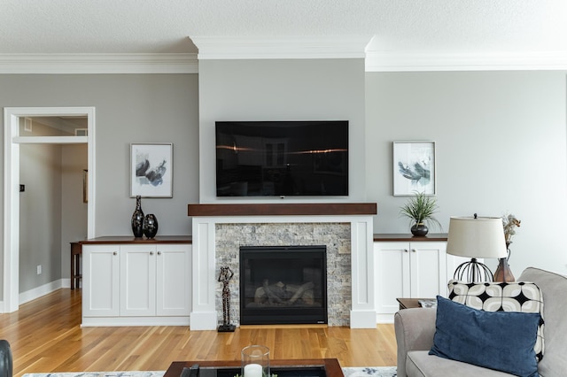 1062 Fox Hill Ln SW, Rochester, MN 55902 - living area with a fireplace, ornamental molding, light wood-style floors, and a textured ceiling