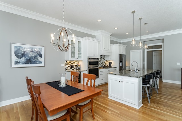 1062 Fox Hill Ln SW, Rochester, MN 55902 - dining space with crown molding, light wood-style floors, a chandelier, and recessed lighting