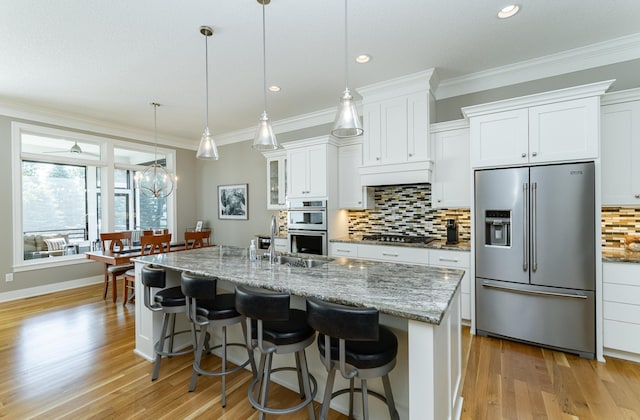 1062 Fox Hill Ln SW, Rochester, MN 55902 - kitchen featuring appliances with stainless steel finishes, decorative backsplash, light wood-type flooring, ornamental molding, and recessed lighting