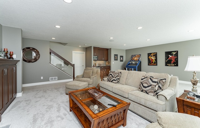 1062 Fox Hill Ln SW, Rochester, MN 55902 - living room with light colored carpet, recessed lighting, stairway, and a textured ceiling