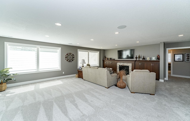 1062 Fox Hill Ln SW, Rochester, MN 55902 - living area featuring light colored carpet, a fireplace, and recessed lighting