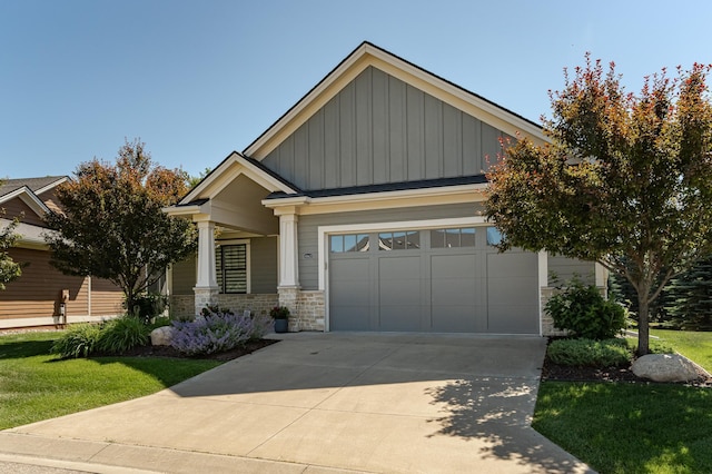 1062 Fox Hill Ln SW, Rochester, MN 55902 - craftsman-style house with board and batten siding, driveway, a garage, stone siding, and a front yard