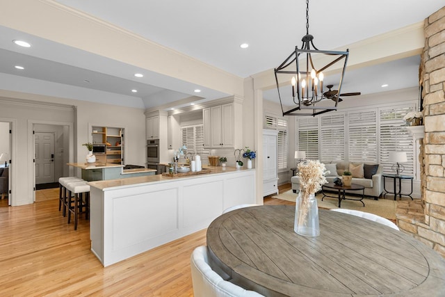 11193 Bluestem Ln, Eden Prairie, MN 55347 - dining space featuring light wood-style flooring, a chandelier, recessed lighting, and crown molding
