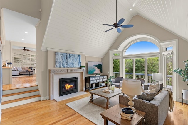 11193 Bluestem Ln, Eden Prairie, MN 55347 - living room with ceiling fan, light wood-style flooring, a glass covered fireplace, high vaulted ceiling, and recessed lighting