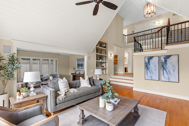 11193 Bluestem Ln, Eden Prairie, MN 55347 - living area with stairs, wood finished floors, ceiling fan, high vaulted ceiling, and built in shelves