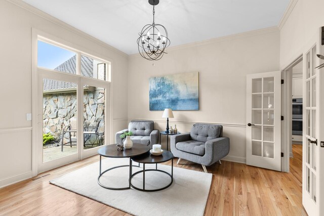 11193 Bluestem Ln, Eden Prairie, MN 55347 - sitting room with crown molding, light wood-type flooring, french doors, and a chandelier