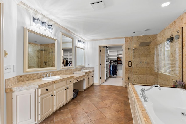11193 Bluestem Ln, Eden Prairie, MN 55347 - full bathroom featuring a stall shower, a walk in closet, double vanity, a bath, and tile patterned flooring