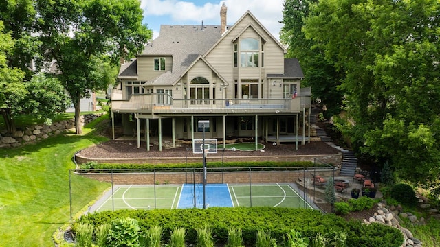 11193 Bluestem Ln, Eden Prairie, MN 55347 - back of house with stairs, a tennis court, a wooden deck, a chimney, and roof with shingles