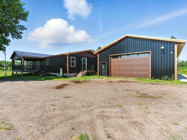 33498 175th St NE, Morrill Twp, MN 56329 - view of front of house featuring a detached garage, board and batten siding, and dirt driveway