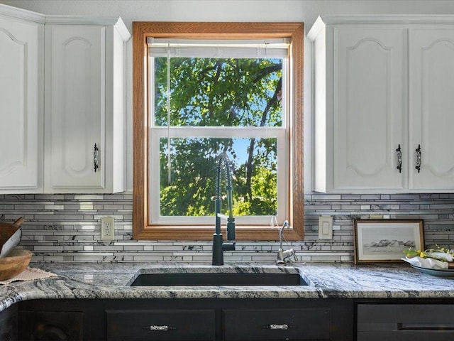 33498 175th St NE, Morrill Twp, MN 56329 - kitchen with decorative backsplash, light stone countertops, and white cabinets