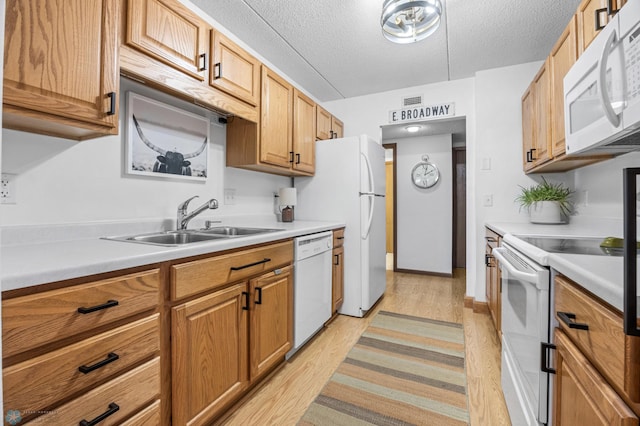 1110 3rd Ave N Unit 201E, Fargo, ND 58102 - kitchen with white appliances, light wood-type flooring, light countertops, and a textured ceiling