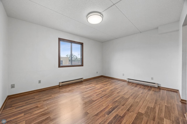 1110 3rd Ave N Unit 201E, Fargo, ND 58102 - unfurnished room with a baseboard heating unit, wood finished floors, and a textured ceiling