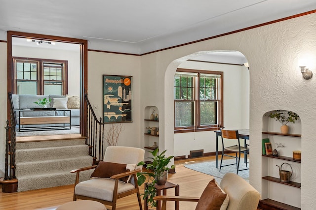 947 Stryker Ave W, Saint Paul, MN 55118 - living area featuring wood finished floors, arched walkways, and built in shelves