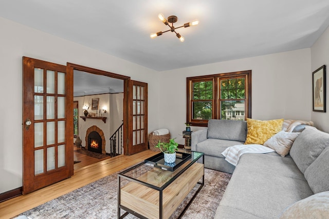 947 Stryker Ave W, Saint Paul, MN 55118 - living area featuring a chandelier, wood finished floors, and a fireplace